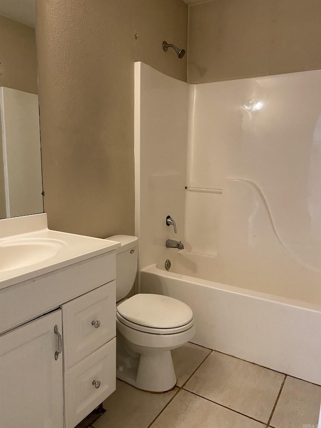 bathroom with tile patterned floors, toilet, shower / washtub combination, and vanity