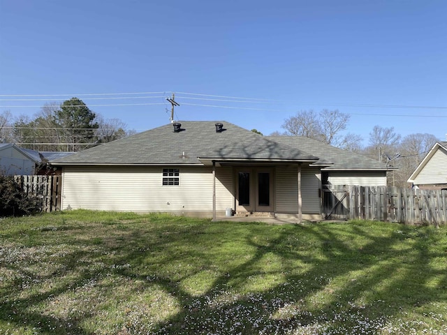 back of house with a yard and fence