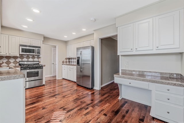 kitchen featuring dark wood finished floors, tile countertops, appliances with stainless steel finishes, and white cabinets