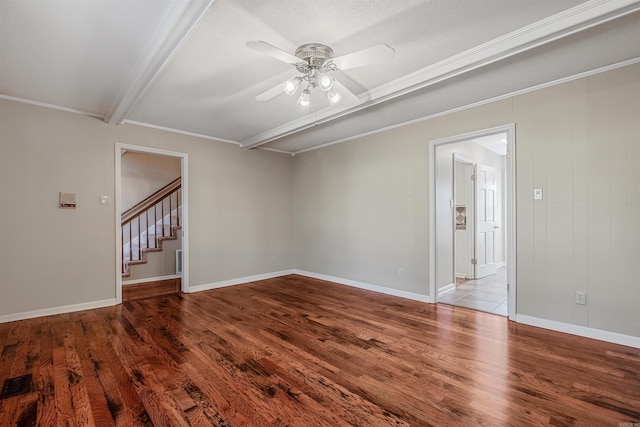 spare room with visible vents, stairway, a ceiling fan, and wood finished floors