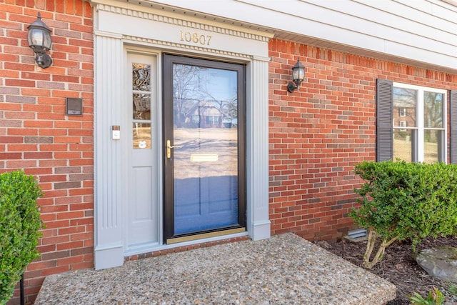 property entrance with brick siding