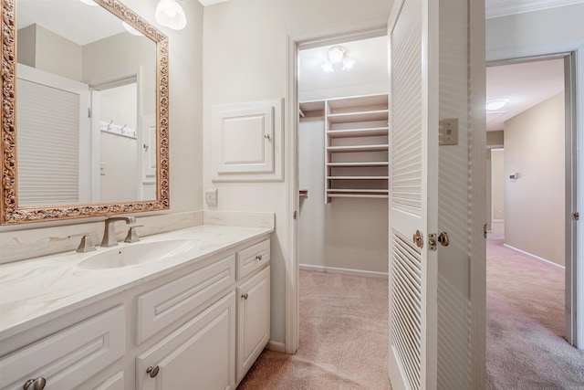 bathroom featuring baseboards and vanity