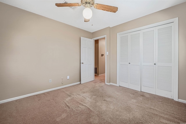 unfurnished bedroom with a closet, carpet flooring, a ceiling fan, and baseboards