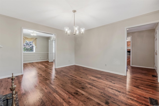 unfurnished room featuring visible vents, ornamental molding, dark wood finished floors, baseboards, and a chandelier