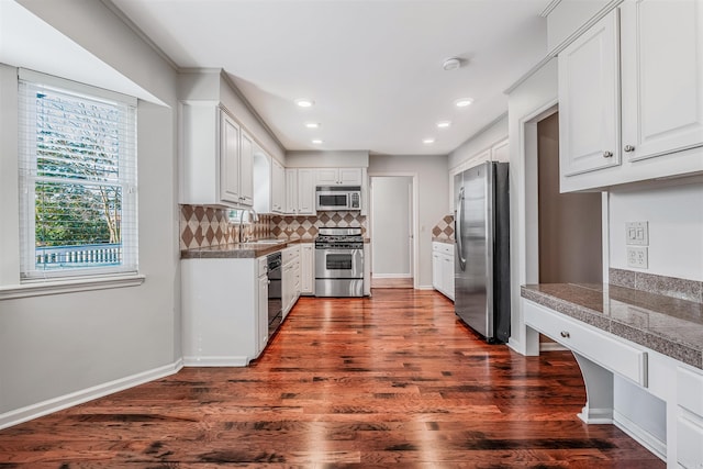 kitchen with tile countertops, tasteful backsplash, white cabinets, and stainless steel appliances