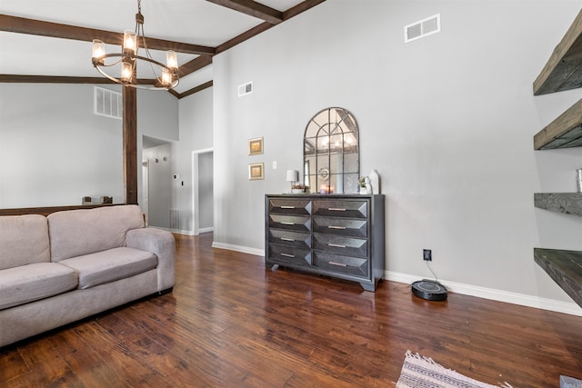 living room featuring wood finished floors, baseboards, visible vents, beam ceiling, and a chandelier