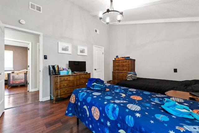 102 Oxford Cv, Jacksonville, AR 72076 - bedroom with baseboards, a chandelier, wood finished floors, and visible vents