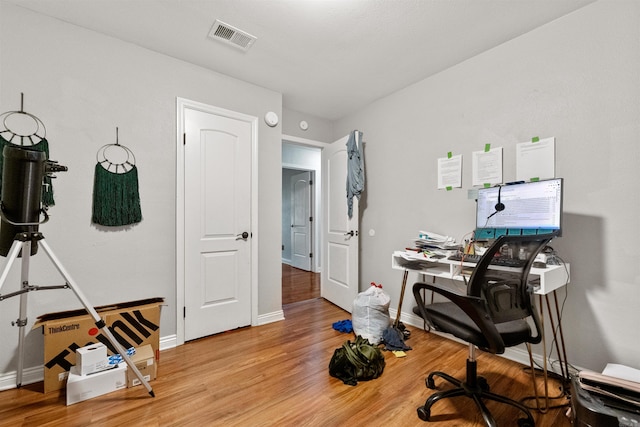102 Oxford Cv, Jacksonville, AR 72076 - home office with baseboards, visible vents, and light wood-style flooring