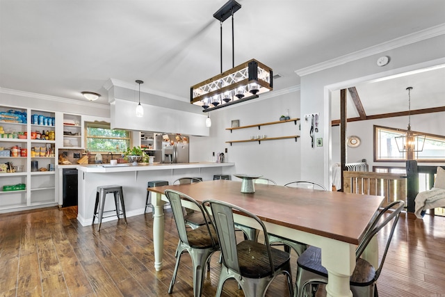 dining area featuring dark wood-type flooring, ornamental molding, plenty of natural light, and a chandelier