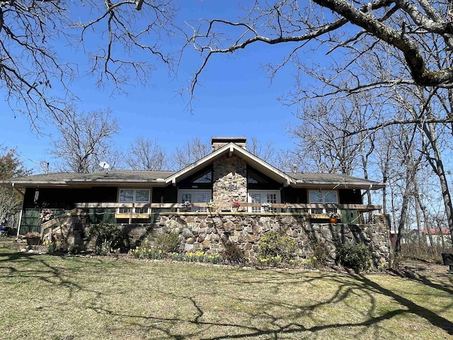 view of front of property featuring stairway, a front yard, and a chimney