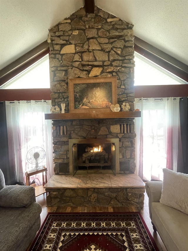 interior details with a stone fireplace and a textured ceiling