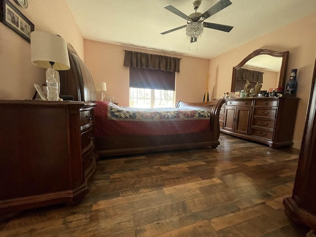 bedroom with dark wood-type flooring and a ceiling fan