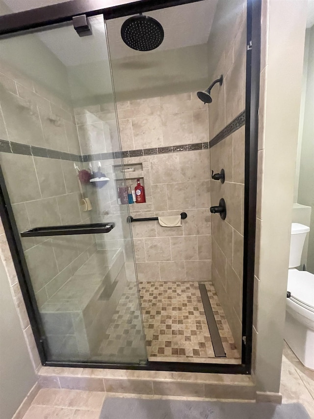 full bathroom with a shower stall and toilet