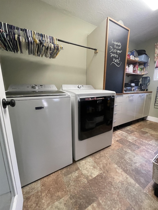 laundry area with a textured ceiling, laundry area, and washer and clothes dryer