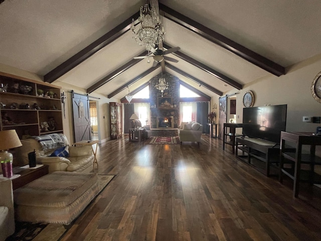 living area with a stone fireplace, lofted ceiling with beams, a barn door, and wood finished floors