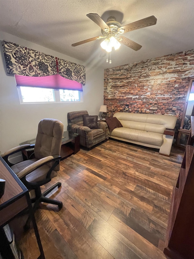 office space with a textured ceiling, a ceiling fan, and hardwood / wood-style flooring