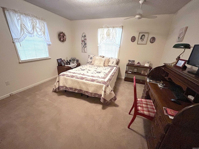 bedroom with multiple windows, carpet flooring, baseboards, and a textured ceiling