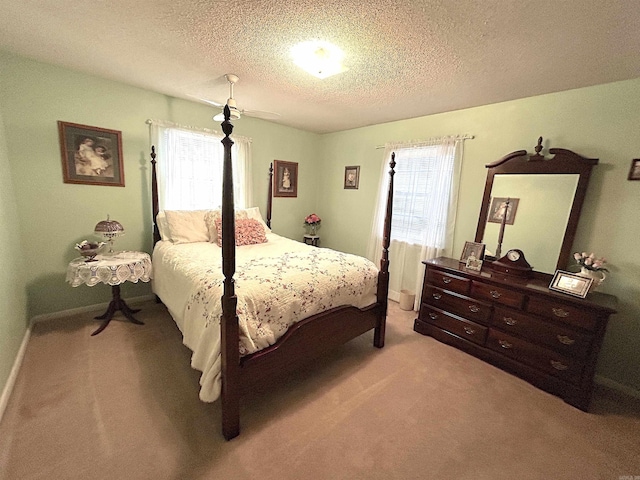 carpeted bedroom with a textured ceiling and baseboards