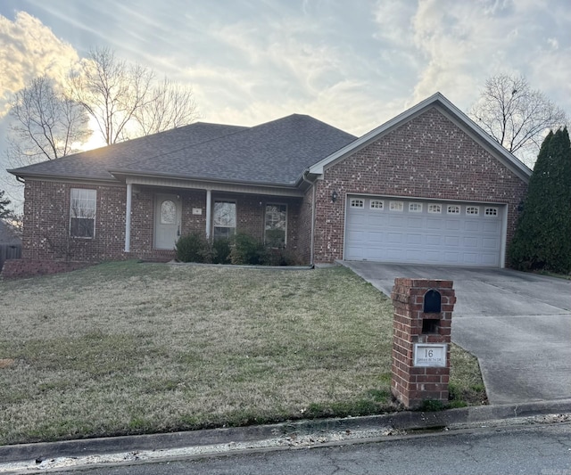 ranch-style house featuring brick siding, a shingled roof, concrete driveway, a front yard, and an attached garage