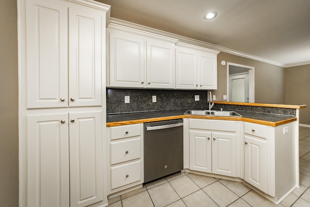 kitchen featuring a sink, dark countertops, a peninsula, light tile patterned floors, and dishwasher