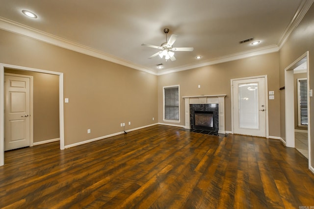 unfurnished living room with visible vents, ornamental molding, a fireplace, dark wood-style floors, and a ceiling fan