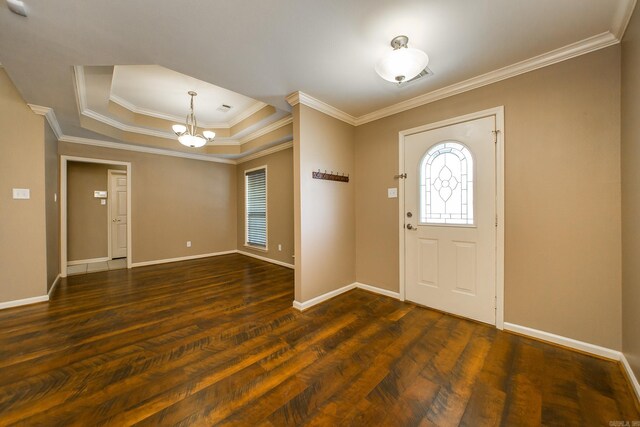 entryway with a chandelier, dark wood finished floors, a raised ceiling, and baseboards