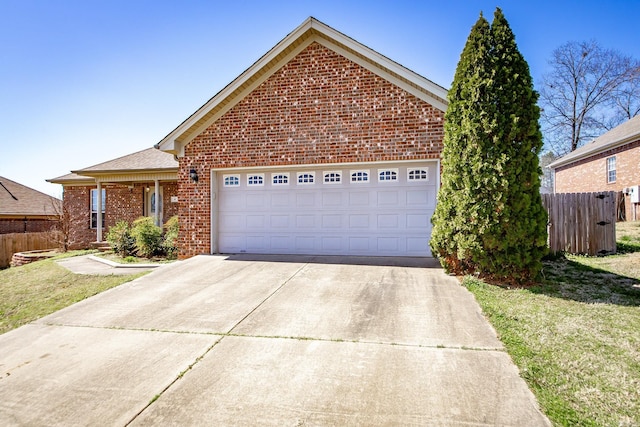 ranch-style home featuring brick siding, concrete driveway, a garage, and fence