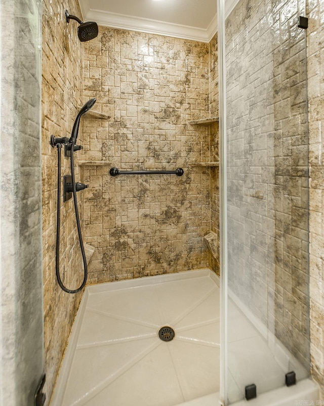 full bathroom featuring crown molding and a shower stall