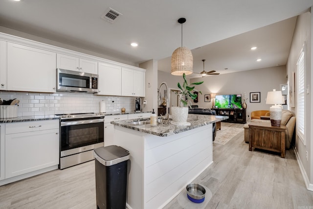 kitchen featuring visible vents, ceiling fan, stainless steel appliances, stone countertops, and white cabinetry