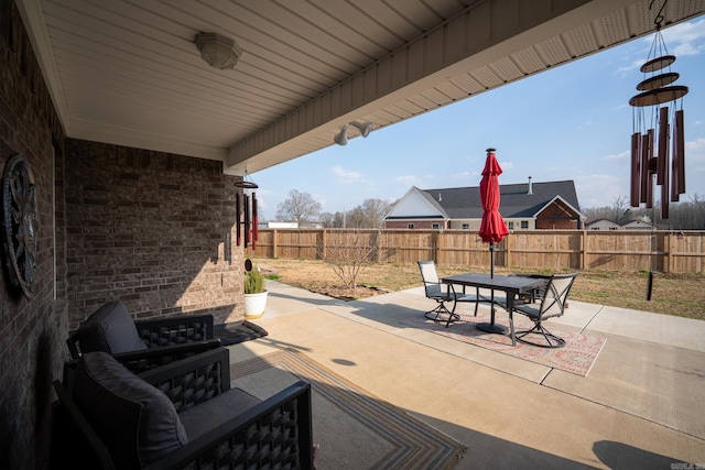 view of patio featuring outdoor dining area and a fenced backyard