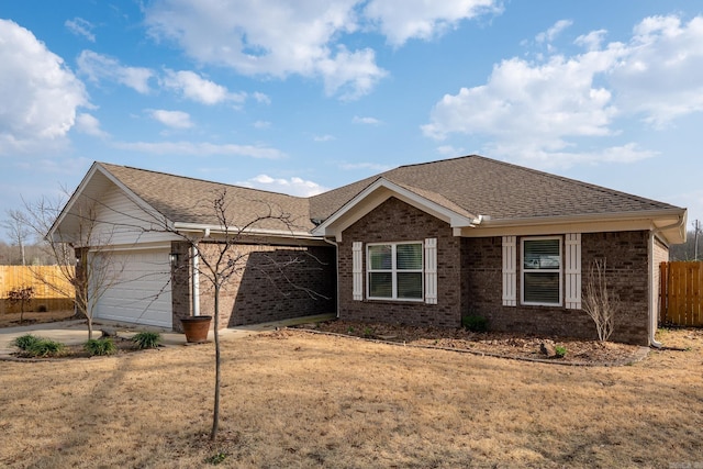 ranch-style home featuring driveway, fence, a shingled roof, a garage, and brick siding