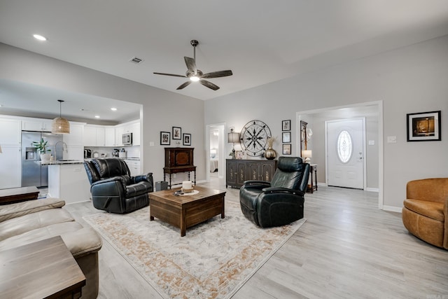 living area featuring visible vents, baseboards, recessed lighting, light wood-style floors, and a ceiling fan