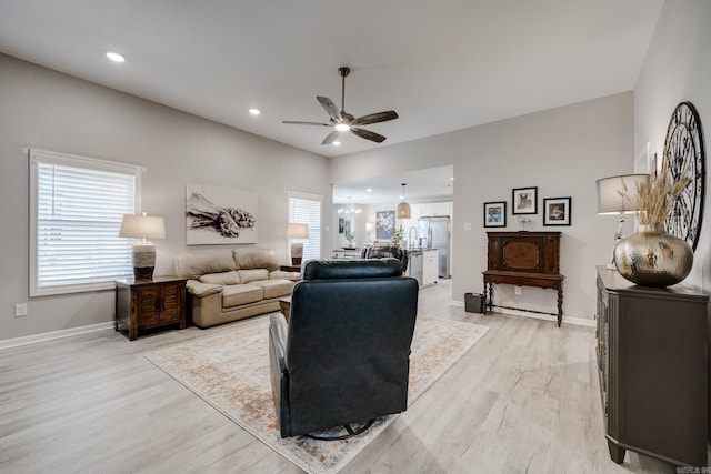 living room featuring recessed lighting, light wood-style flooring, baseboards, and ceiling fan