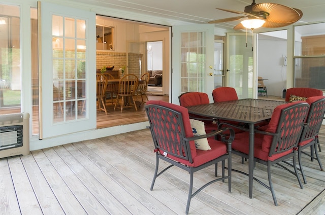 sunroom with french doors, heating unit, and ceiling fan