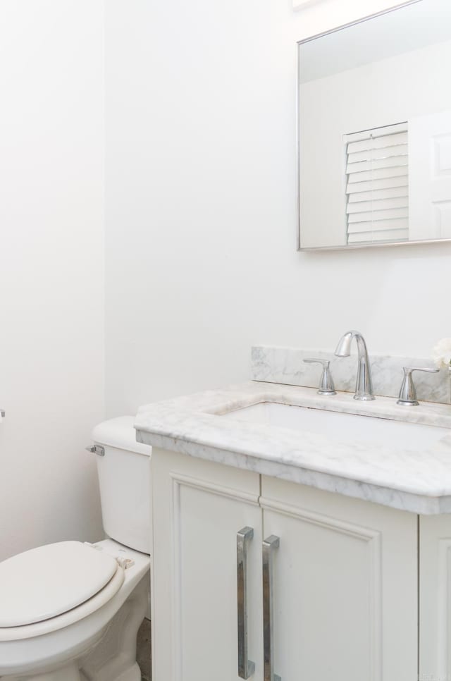 bathroom with toilet and vanity