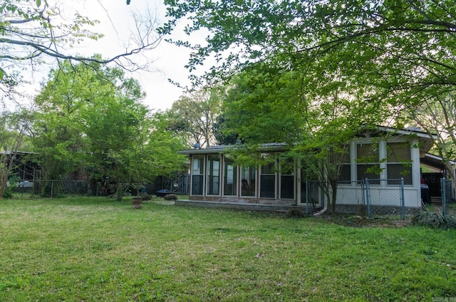 view of yard featuring fence and a sunroom