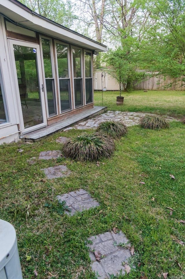 view of yard with an outdoor structure and fence