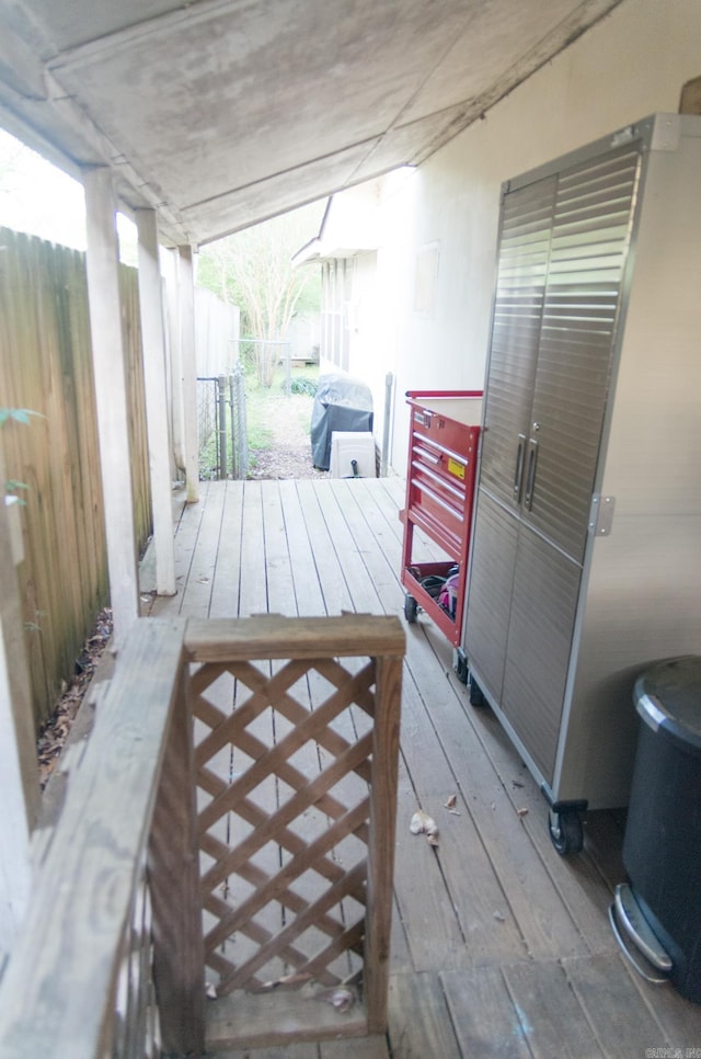 wooden deck featuring a grill and fence