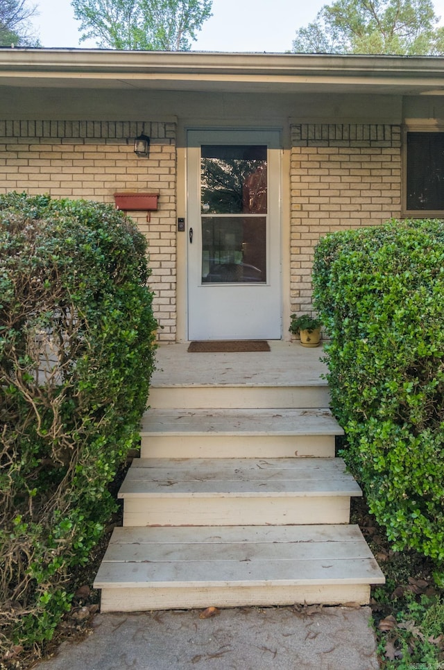 property entrance featuring brick siding