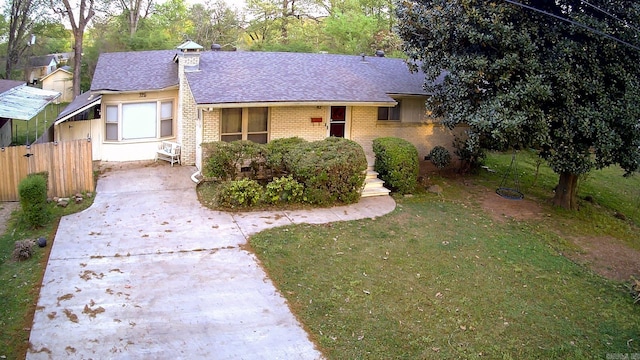 ranch-style home featuring a front lawn, brick siding, and a shingled roof