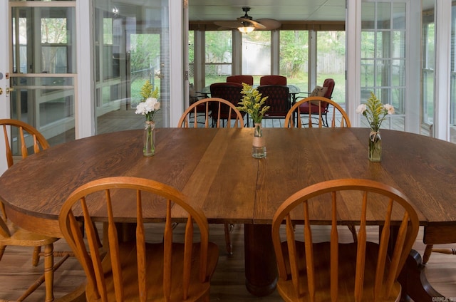 dining space with wood finished floors and ceiling fan