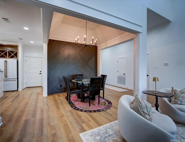 dining area featuring light wood-type flooring, visible vents, an inviting chandelier, and recessed lighting