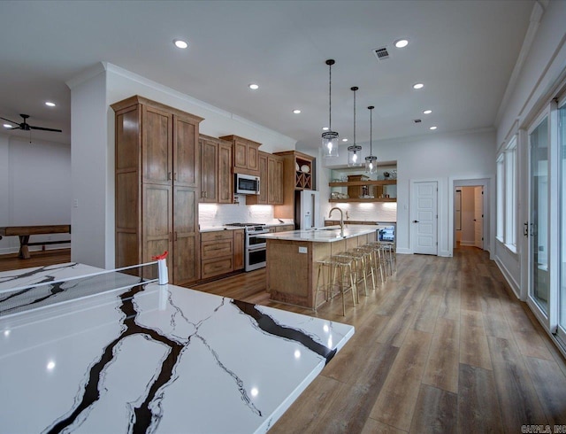 kitchen with open shelves, brown cabinetry, visible vents, and appliances with stainless steel finishes