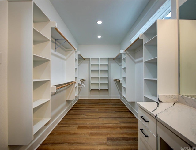 walk in closet featuring dark wood finished floors