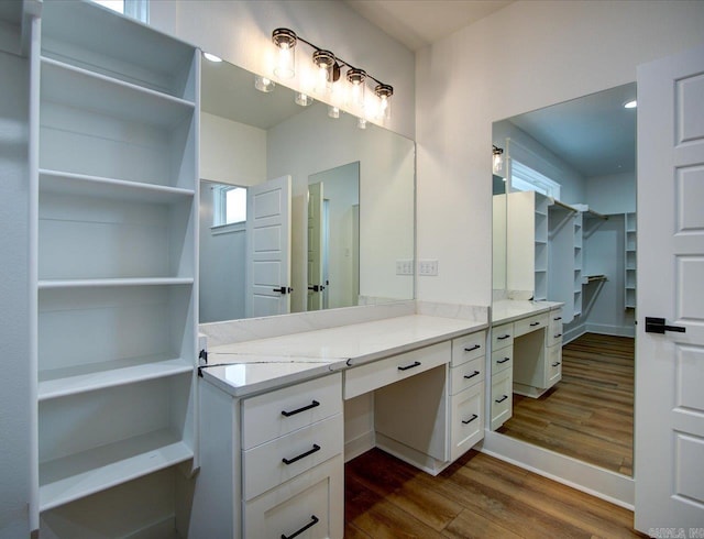 bathroom featuring wood finished floors and vanity
