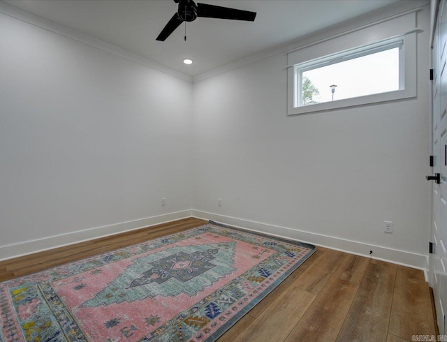 unfurnished room with a ceiling fan, hardwood / wood-style flooring, recessed lighting, crown molding, and baseboards
