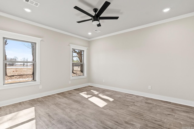 spare room with visible vents, baseboards, and ornamental molding