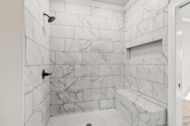 full bath featuring a tile shower