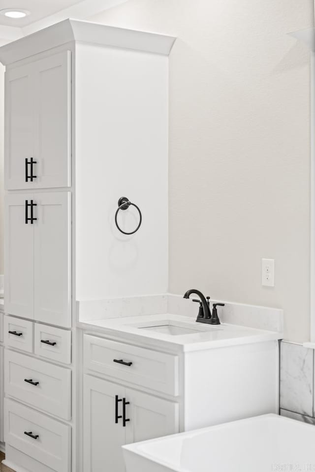 bathroom featuring a sink and a freestanding bath