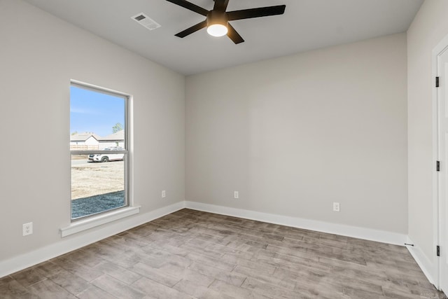 empty room featuring visible vents, baseboards, wood finished floors, and a ceiling fan